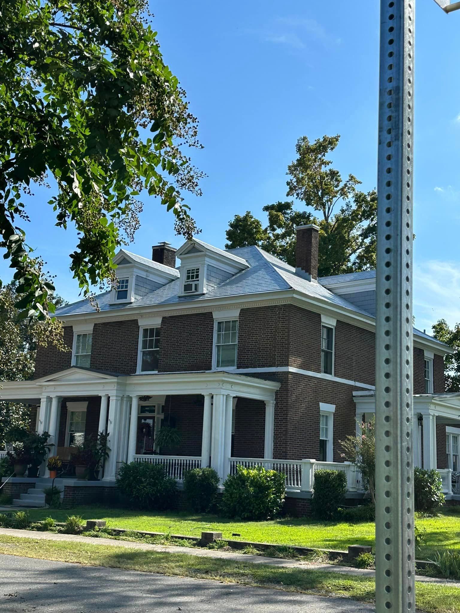 A Brick House with a White Porch and a Metal Roof - Chester, VA - A. Townsley Contracting