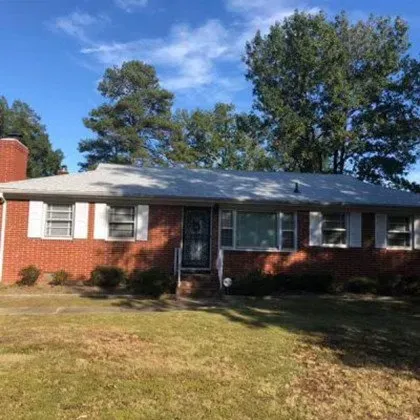A Brick House with a White Roof and White Shutters - Chester, VA - A. Townsley Contracting