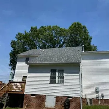 A White House with a Brick Foundation and a Gray Roof - Chester, VA - A. Townsley Contracting