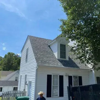 A Man in a Cowboy Hat is standing in front of a White House - Chester, VA - A. Townsley Contracting