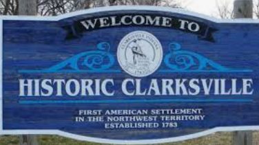 A blue sign reading Welcome to Historic Clarksville, First American Settlement in the Northwest Territory, Established 1783. A blue sign reading Welcome to Historic Clarksville, First American Settlement in the Northwest Territory, Established 1783.
