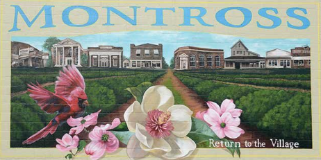A mural showing a town street scene in Montross, with a red cardinal, white magnolia, and pink dogwood flowers in the front. A mural showing a town street scene in Montross, with a red cardinal, white magnolia, and pink dogwood flowers in the front.