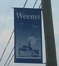 Blue vertical banner reading Weems with birds and a ferry illustration beside a utility pole.