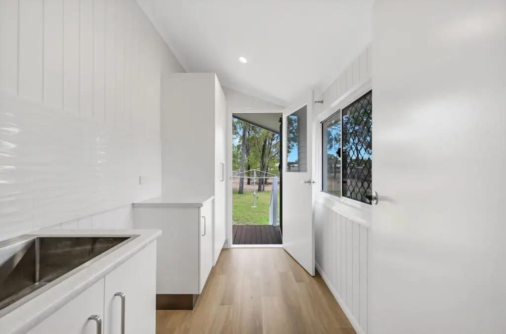 A Long Hallway With White Cabinets and a Sink in a House — Drawing Works In Townsville City, QLD