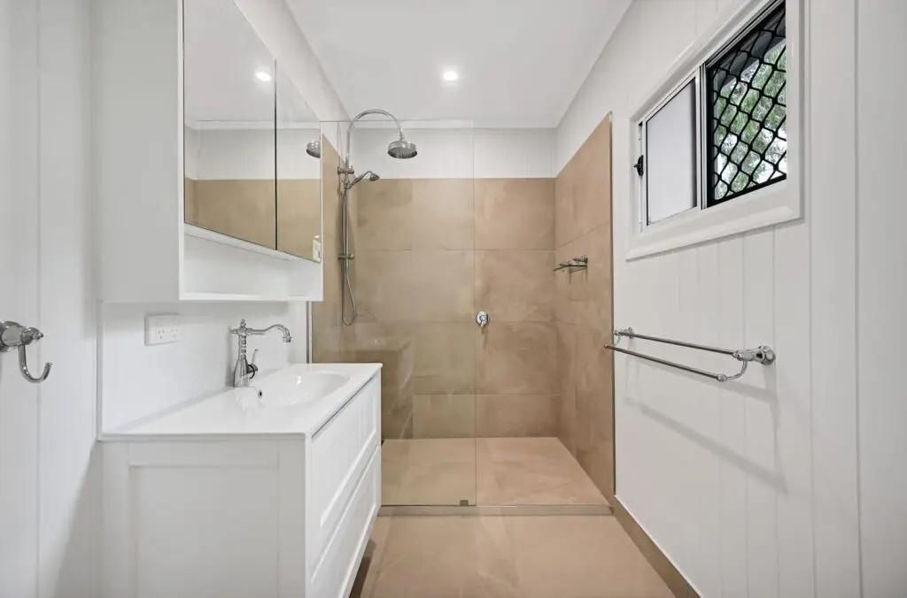 A Bathroom With a Walk in Shower, Sink, Mirror and Window — Drawing Works In Townsville City, QLD