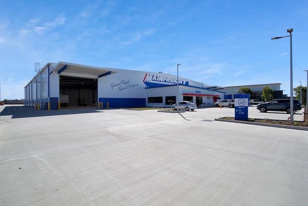 A Large Building With a Lot of Cars Parked in Front of It — Drawing Works In Townsville City, QLD