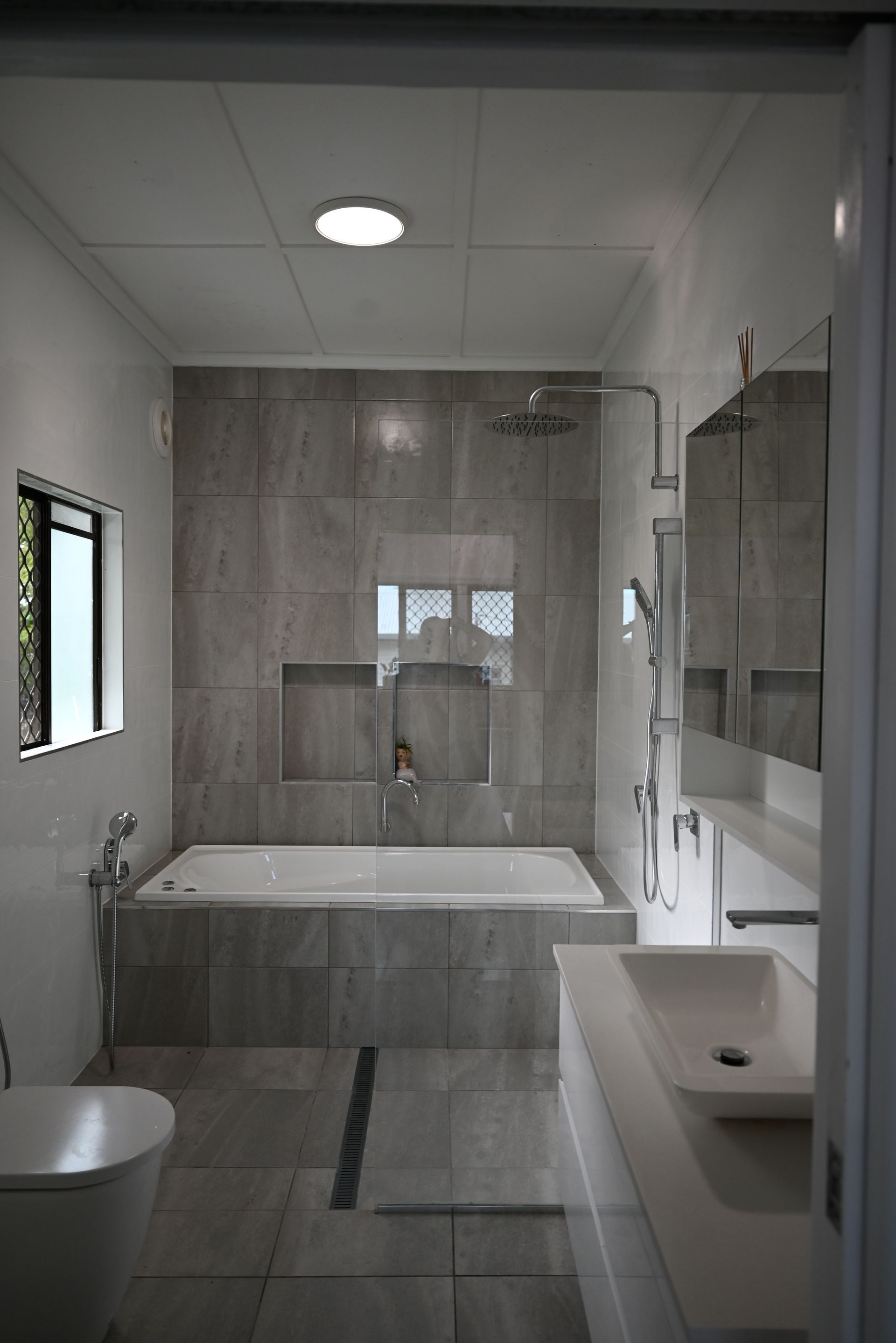 A Small White House is Sitting in the Middle of a Lush Green Field — Drawing Works In Townsville City, QLD