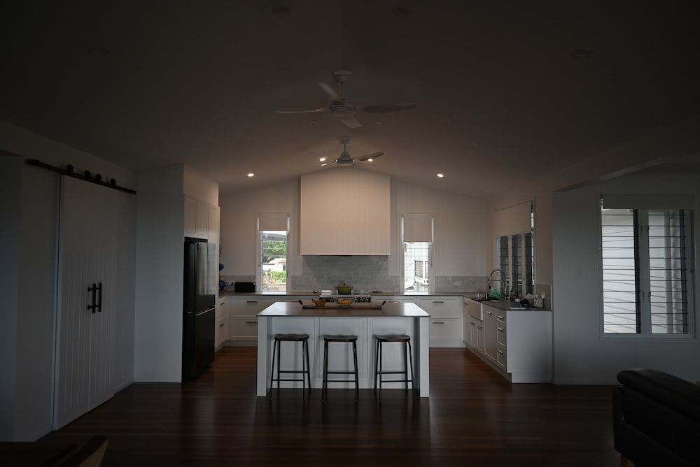 A Kitchen With a Large Island and Three Stools — Drawing Works In Townsville City, QLD