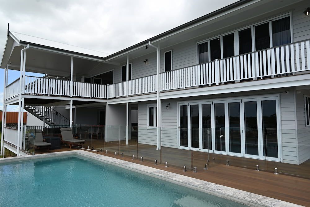 A Large White House With a Swimming Pool in Front of It — Drawing Works In Hughenden, QLD