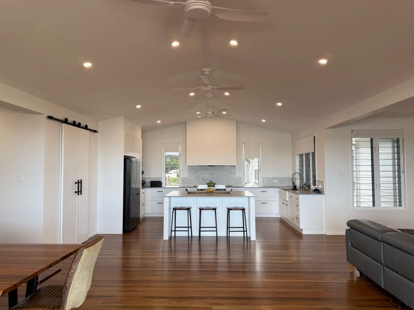 A White House With a Black Door and White Railing — Drawing Works In Townsville City, QLD