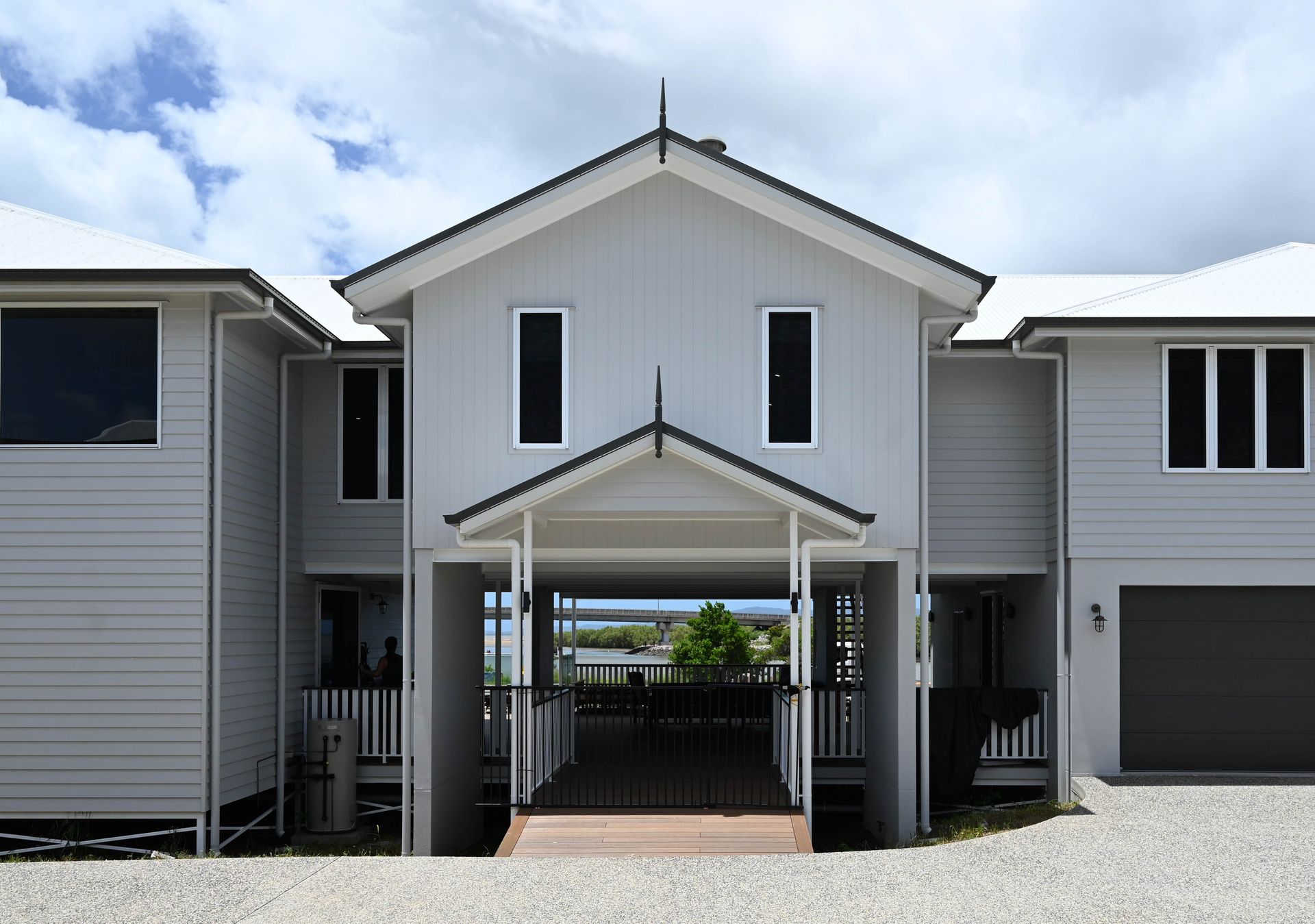 A White House With a Porch is Sitting on Top of a Lush Green Field — Drawing Works In Townsville City, QLD