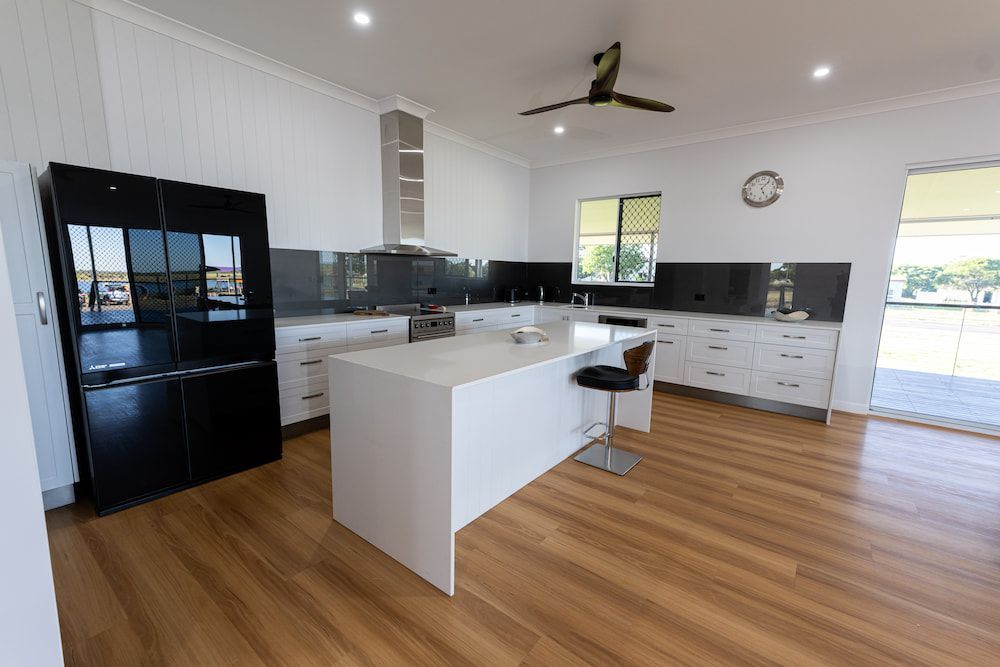 A Large White House With a Palm Tree in Front of It — Drawing Works In Townsville City, QLD