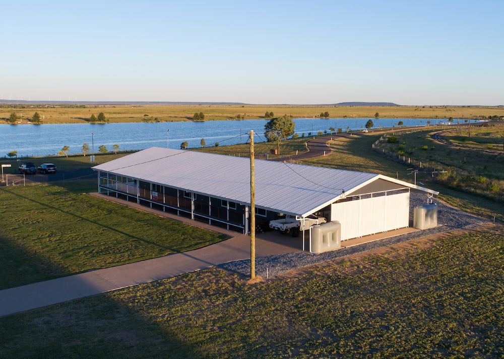 An Aerial View of a Large White Building Next to a Lake— Drawing Works In Townsville City, QLD