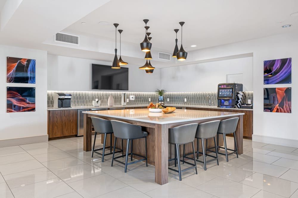 a large kitchen with a large island and stools at Marquis at Chandler in Chandler, AZ.