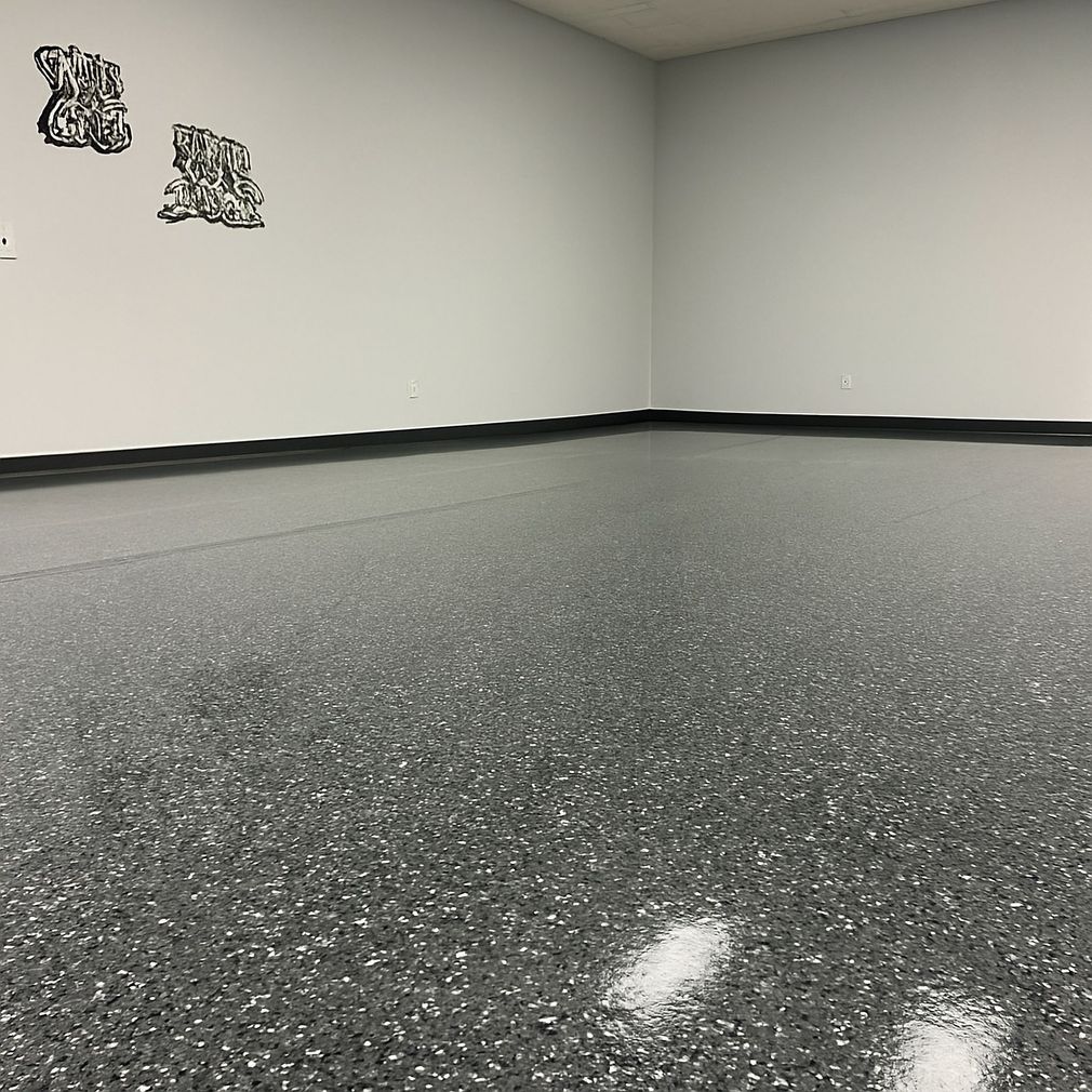 Worker pouring or spreading glossy beige floor coating in a white room
