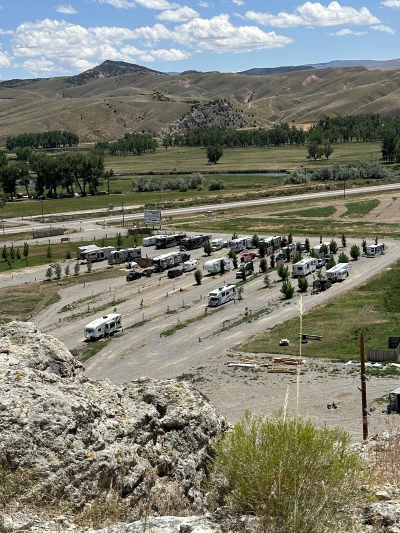 An aerial view of a parking lot with a lot of vehicles parked in it.