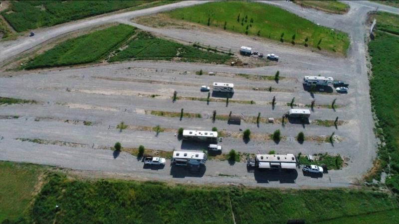 An aerial view of a parking lot with a lot of cars parked in it
