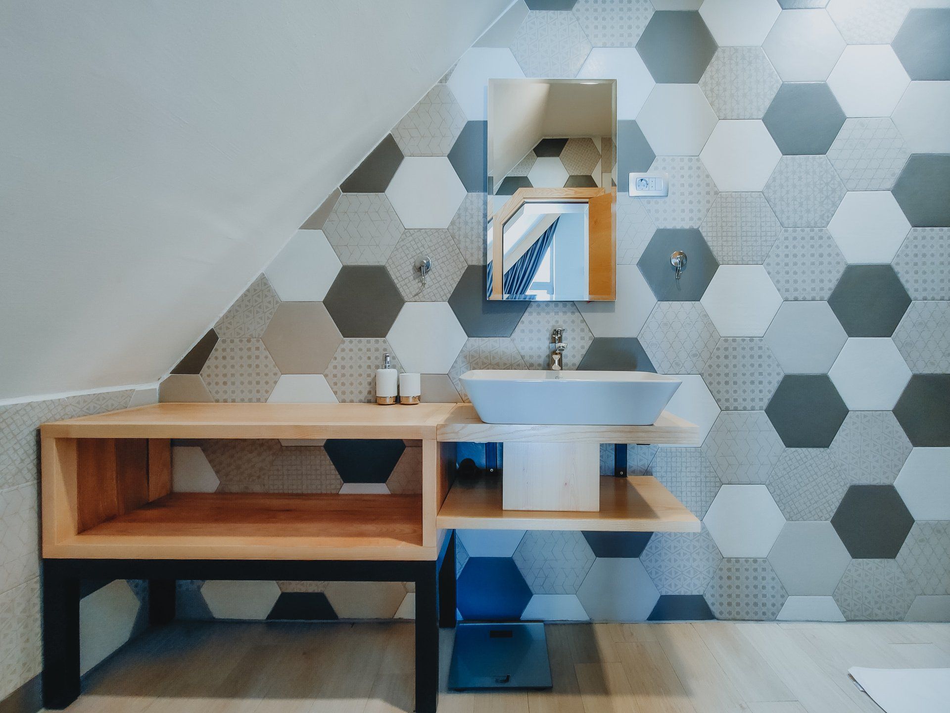 A bathroom with hexagonal tiles and a sink