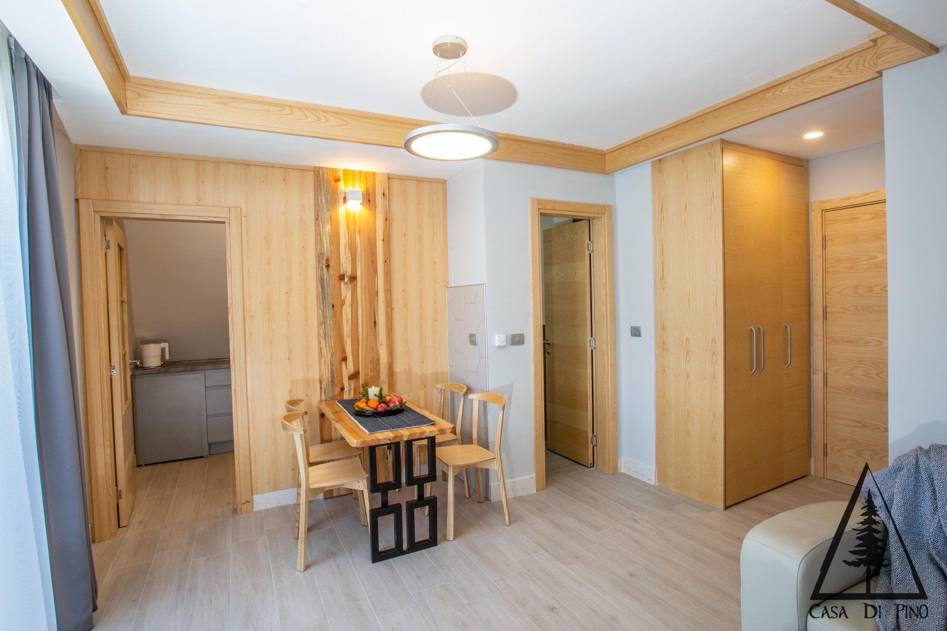 A dining room with a table and chairs inside a hotel apartment.