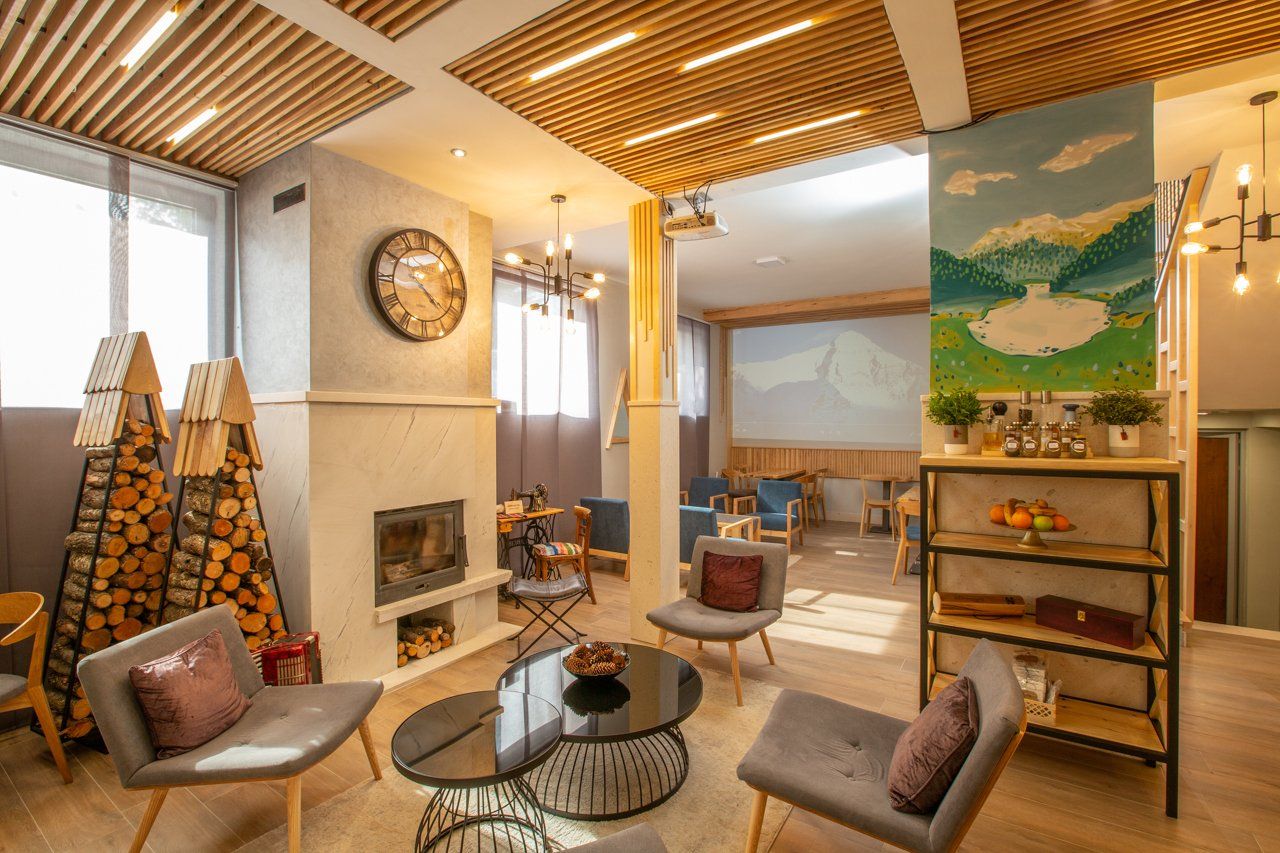 A hotel lounge bar filled with furniture and a fireplace.