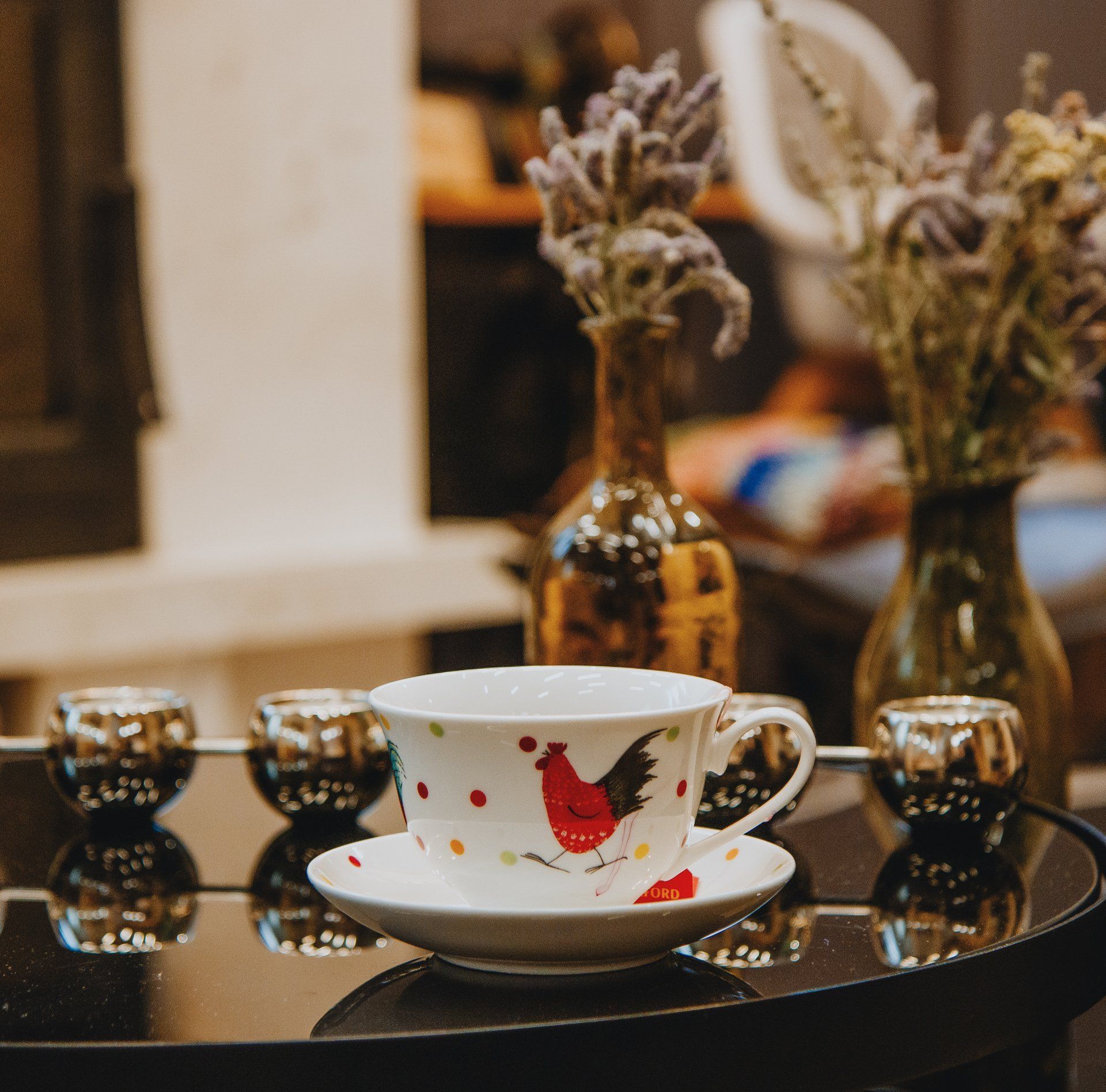 A cup and saucer with a rooster on it