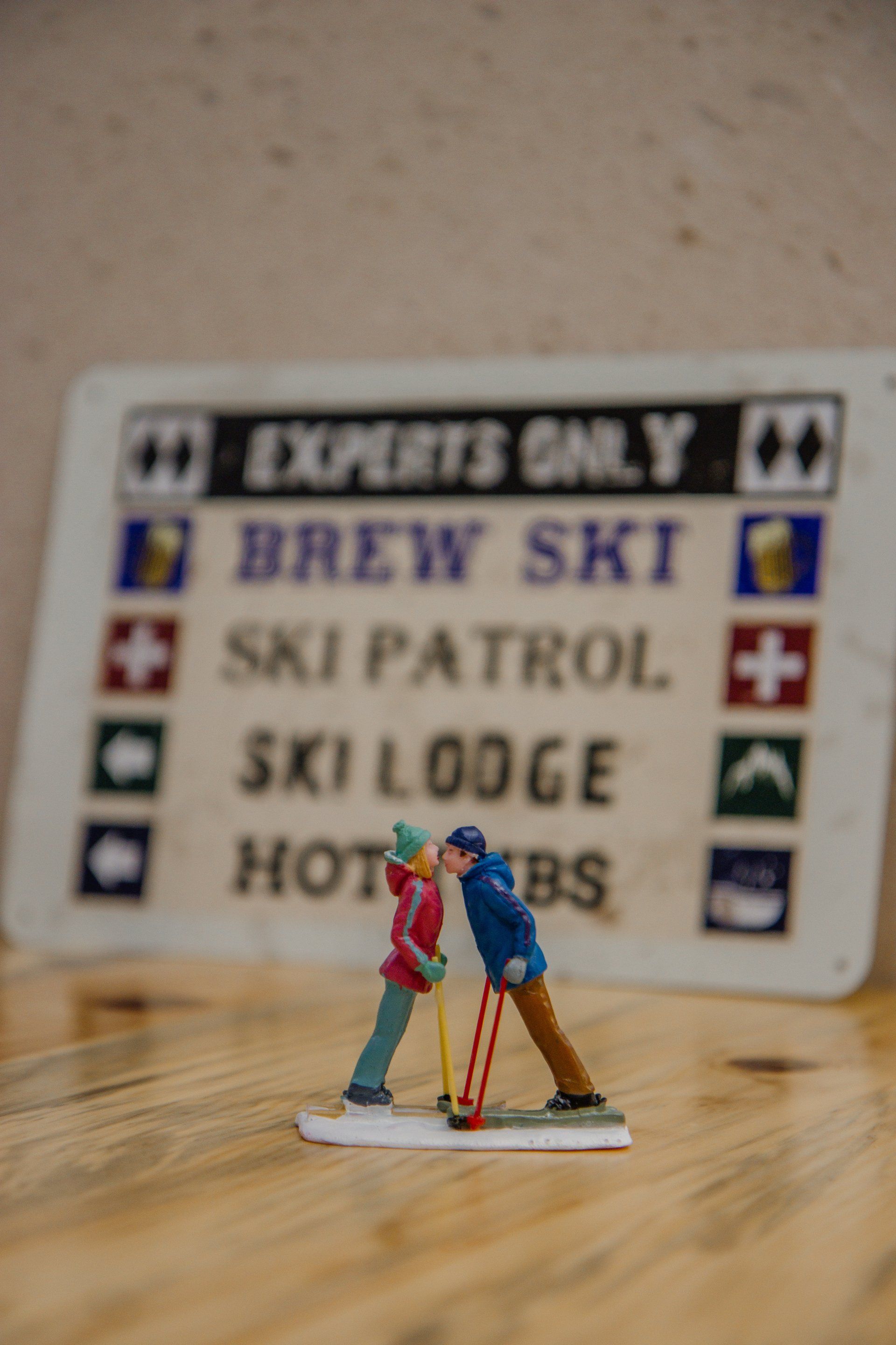 A figurine of two people skiing next to a sign that says experts only
