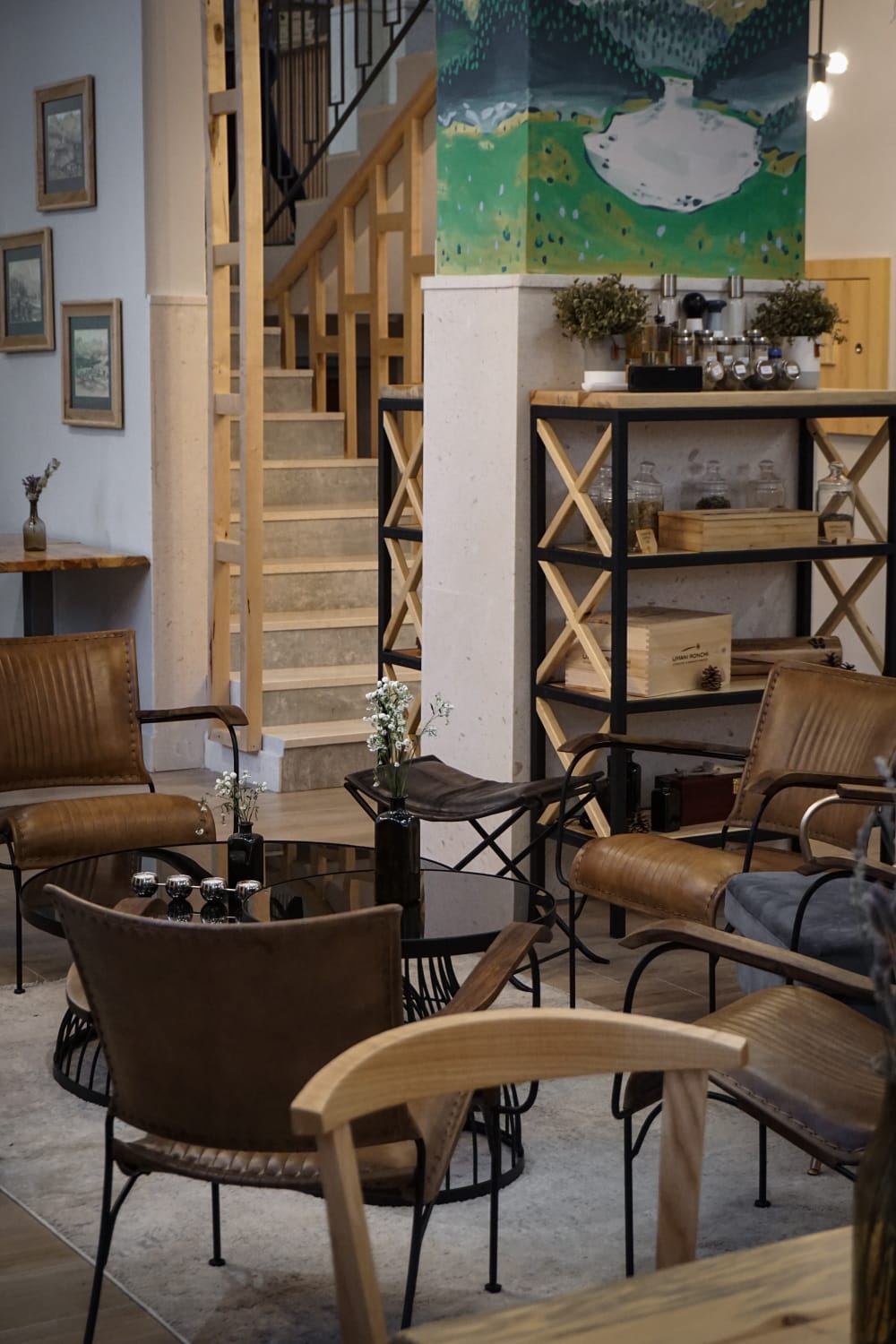 A hotel lounge filled with furniture and a staircase