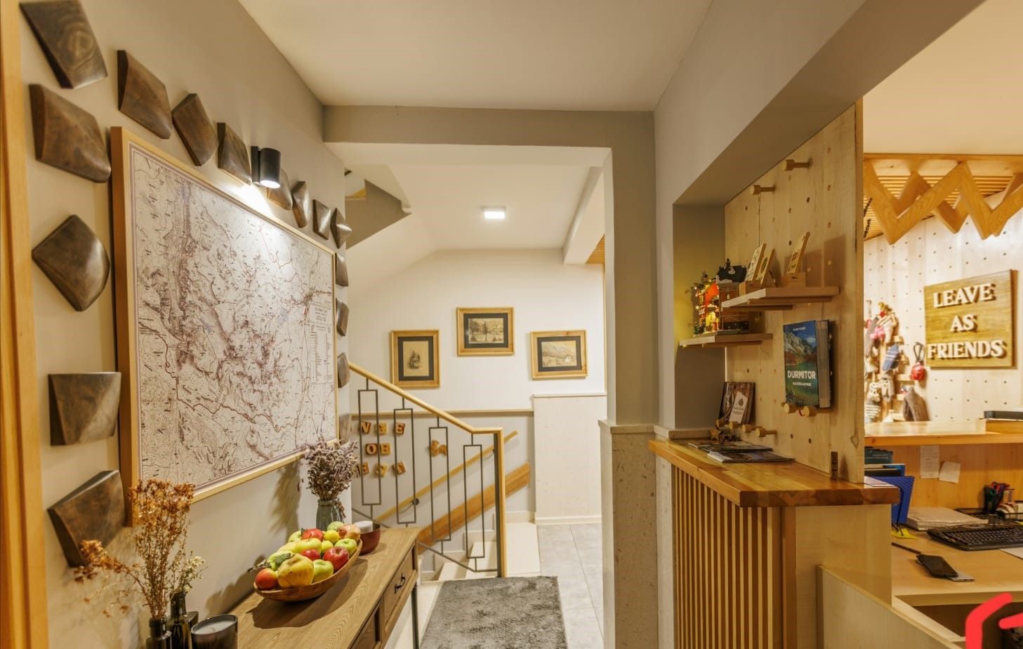 A hallway with a wooden table and a map on the wall.