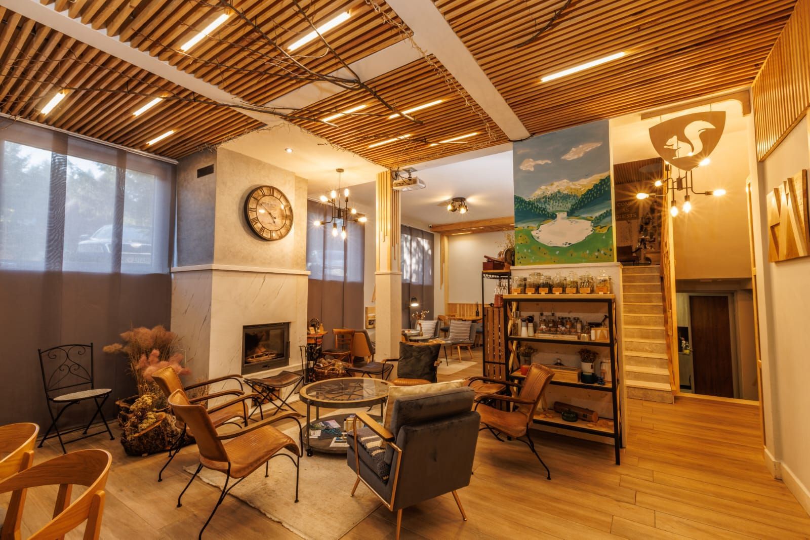 A small hotel lounge bar filled with furniture and a fireplace.