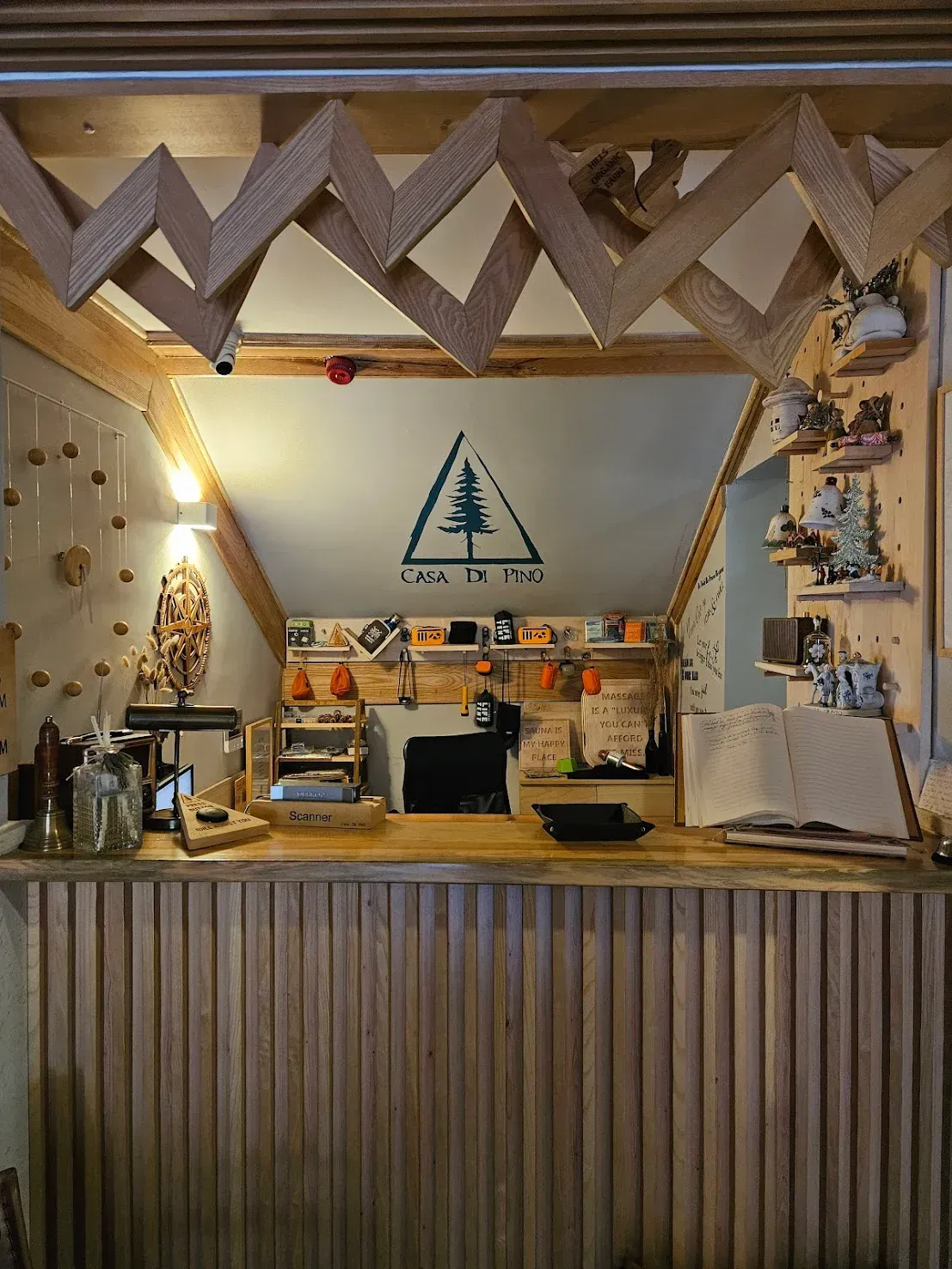 Wooden counter with a logo of a tree inside a triangle. Zigzag wooden accents above the counter.