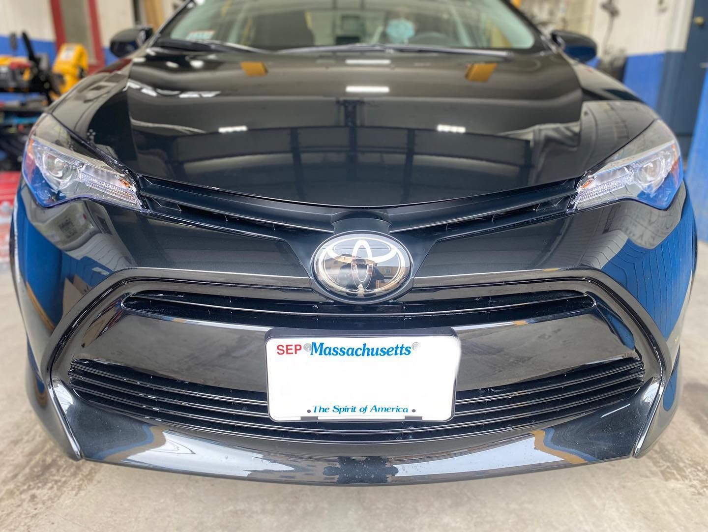 Black Toyota Corolla with a Massachusetts license plate.