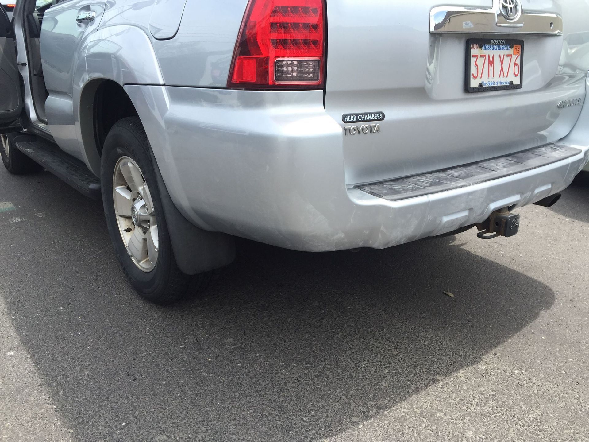 Silver Toyota 4Runner, rear view, door open, on asphalt, Utah license plate.