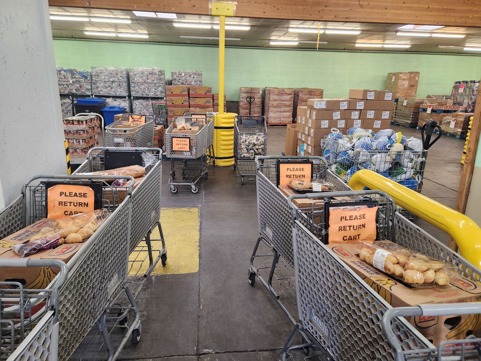 A warehouse filled with shopping carts and boxes.