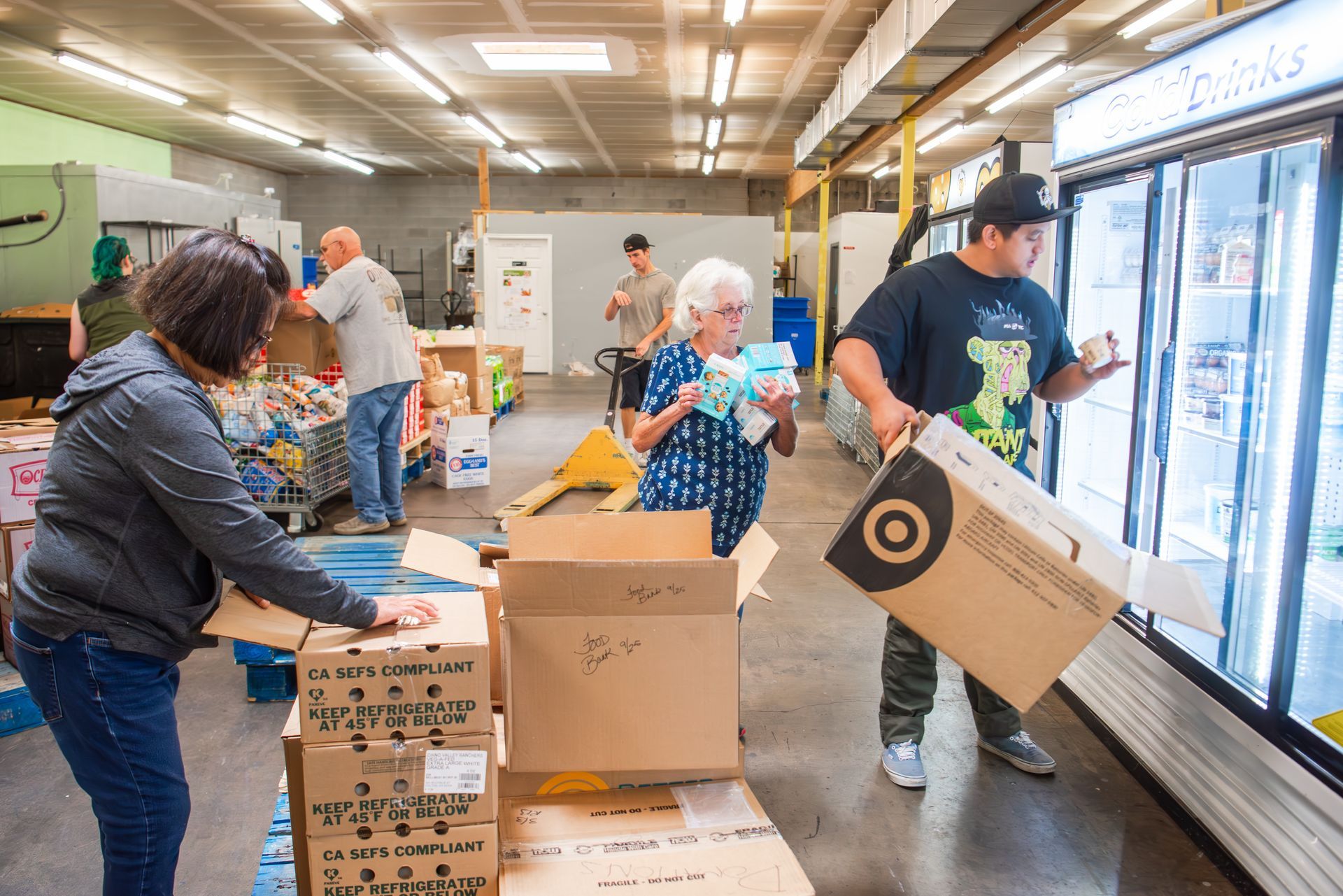 A group of people are packing boxes in a store.