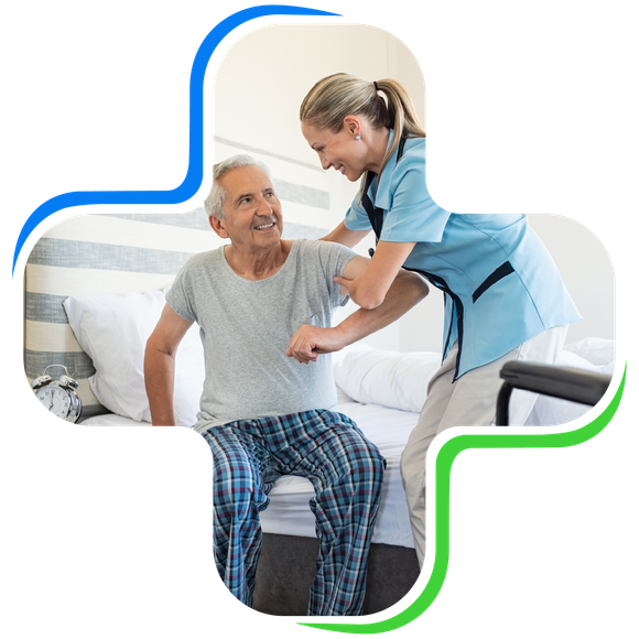Smiling nurse assisting senior man to get up from bed. Caring nurse supporting patient while getting up from bed and move towards wheelchair at home. Helping elderly disabled man standing up.
