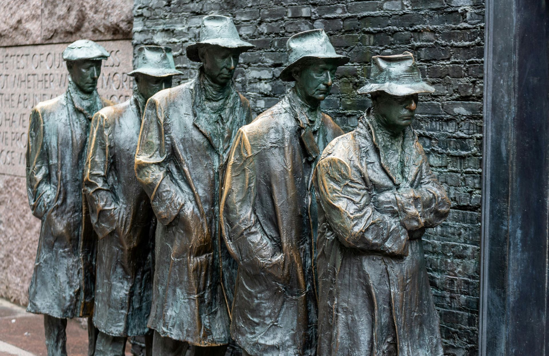 Bronze sculpture of men in line, wearing coats and hats; Washington, D.C.