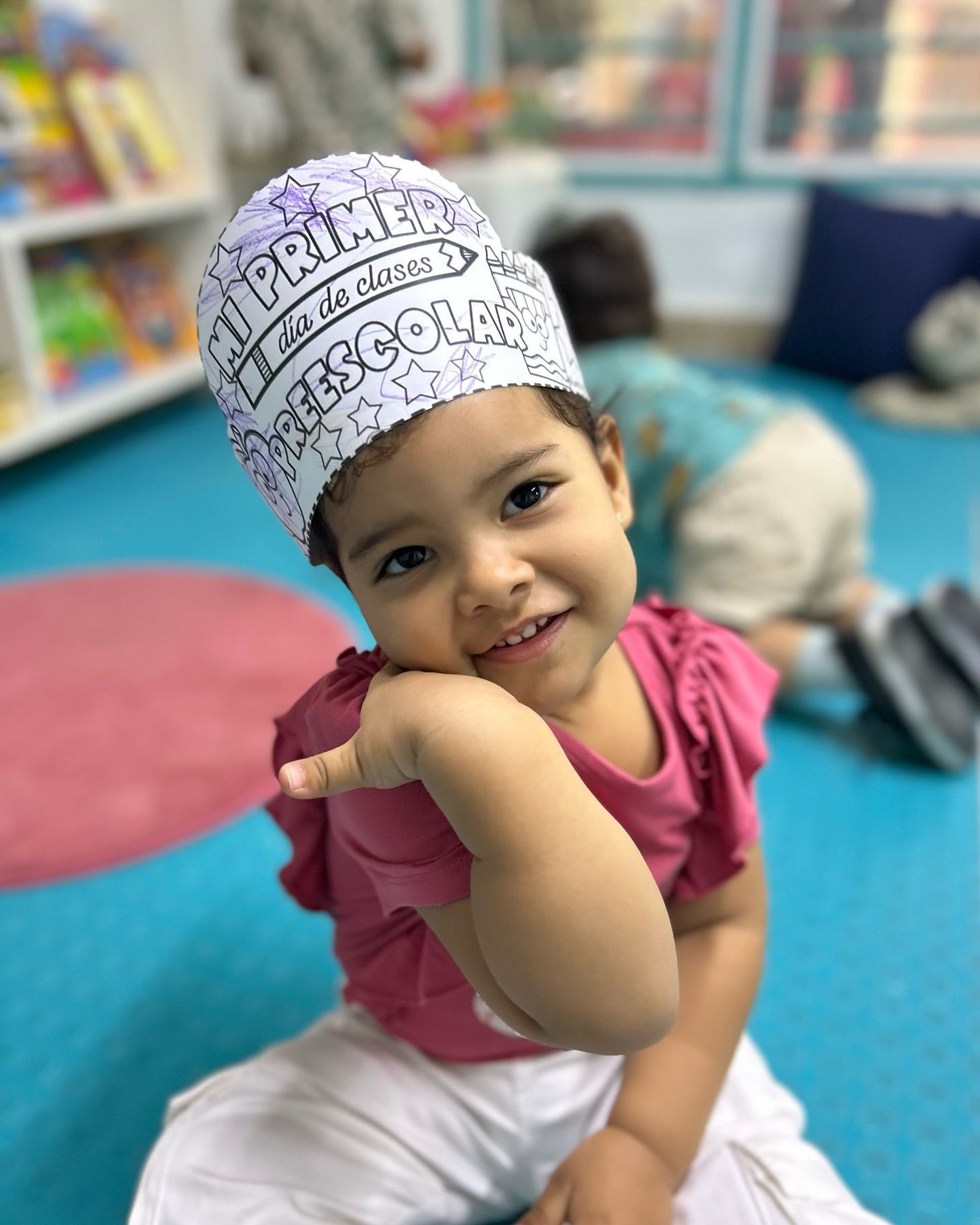 Dos niños se columpian en un columpio de neumático al aire libre; uno sonríe a la cámara, sujetando la cadena.