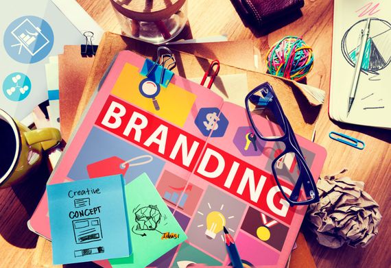 A book titled branding is sitting on top of a wooden table.