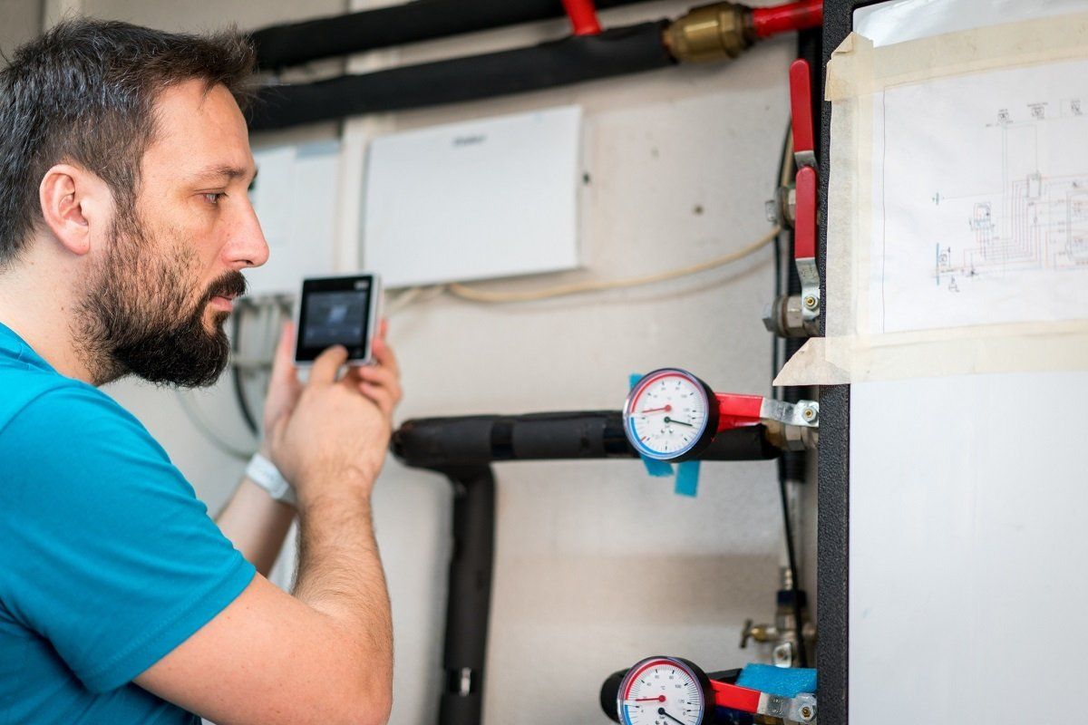 Plumber using phone | Gray, GA | Advanced Plumbing Co.