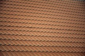 A view of a residential house with a sloping brown roof made of tiles in Hobart TAS.