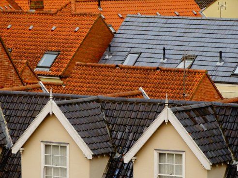 Houses in Hobart TAS with light and dark colour roofs.