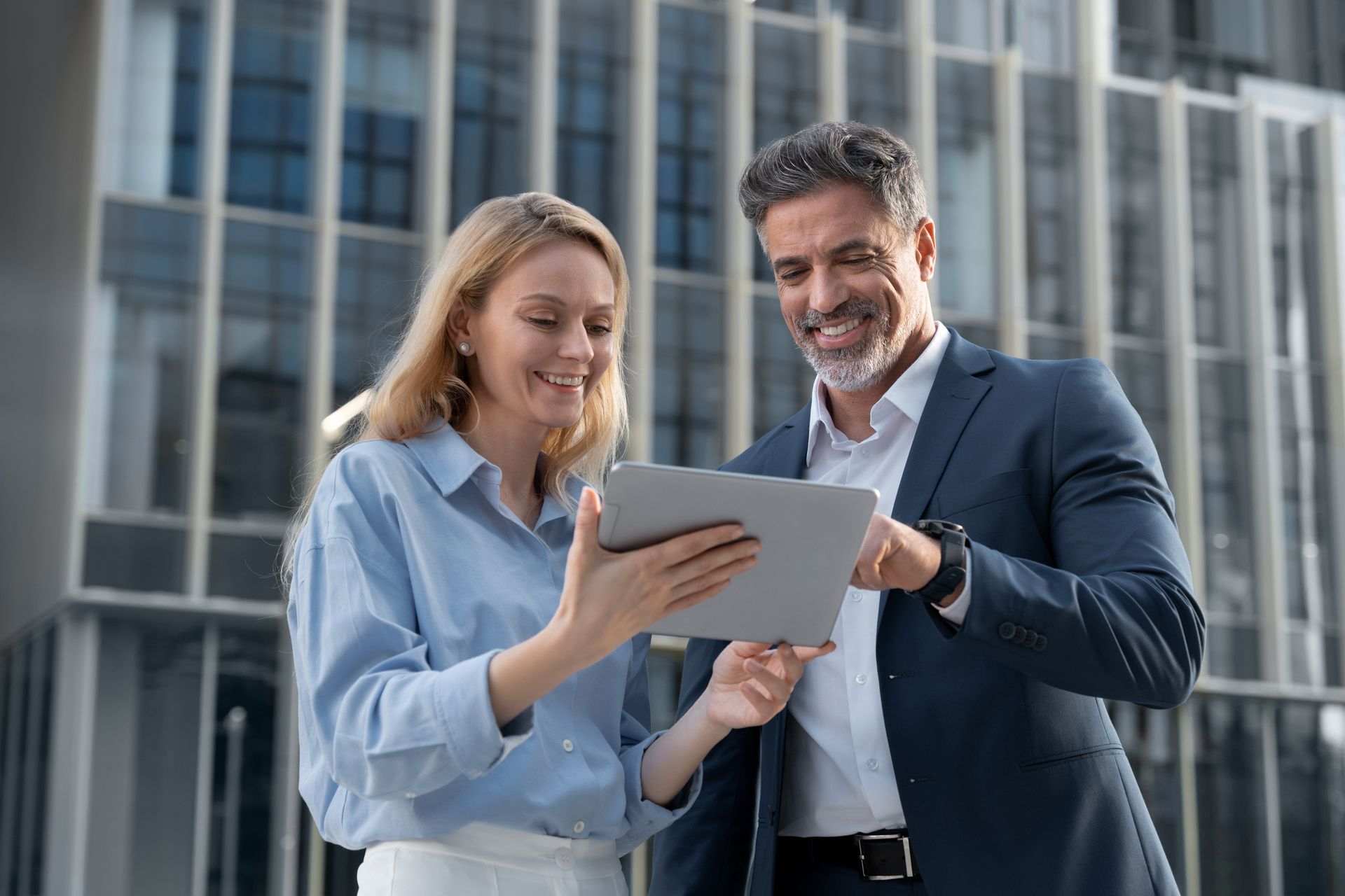 Woman and man looking at tablet