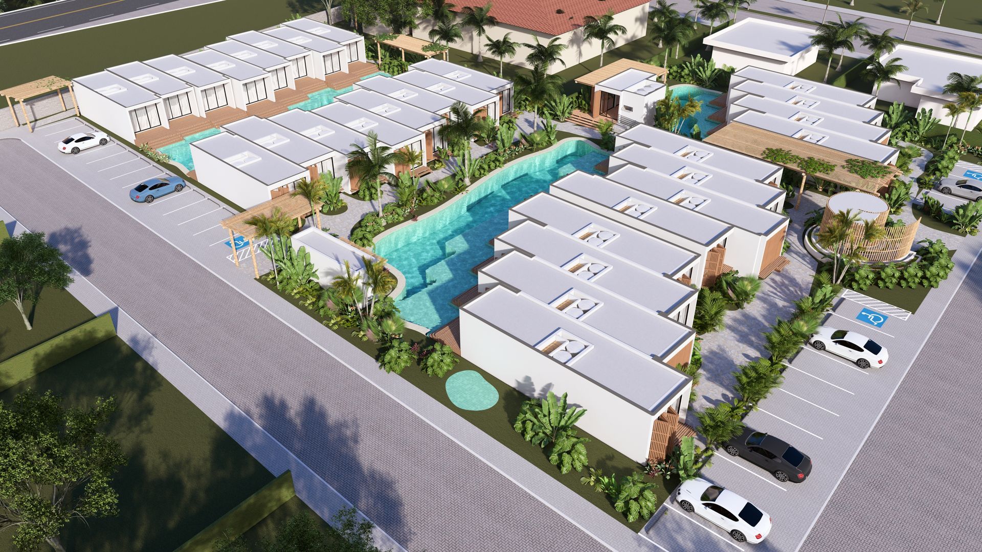 Vista aérea de um hotel moderno com edifícios brancos, piscina e estacionamento.