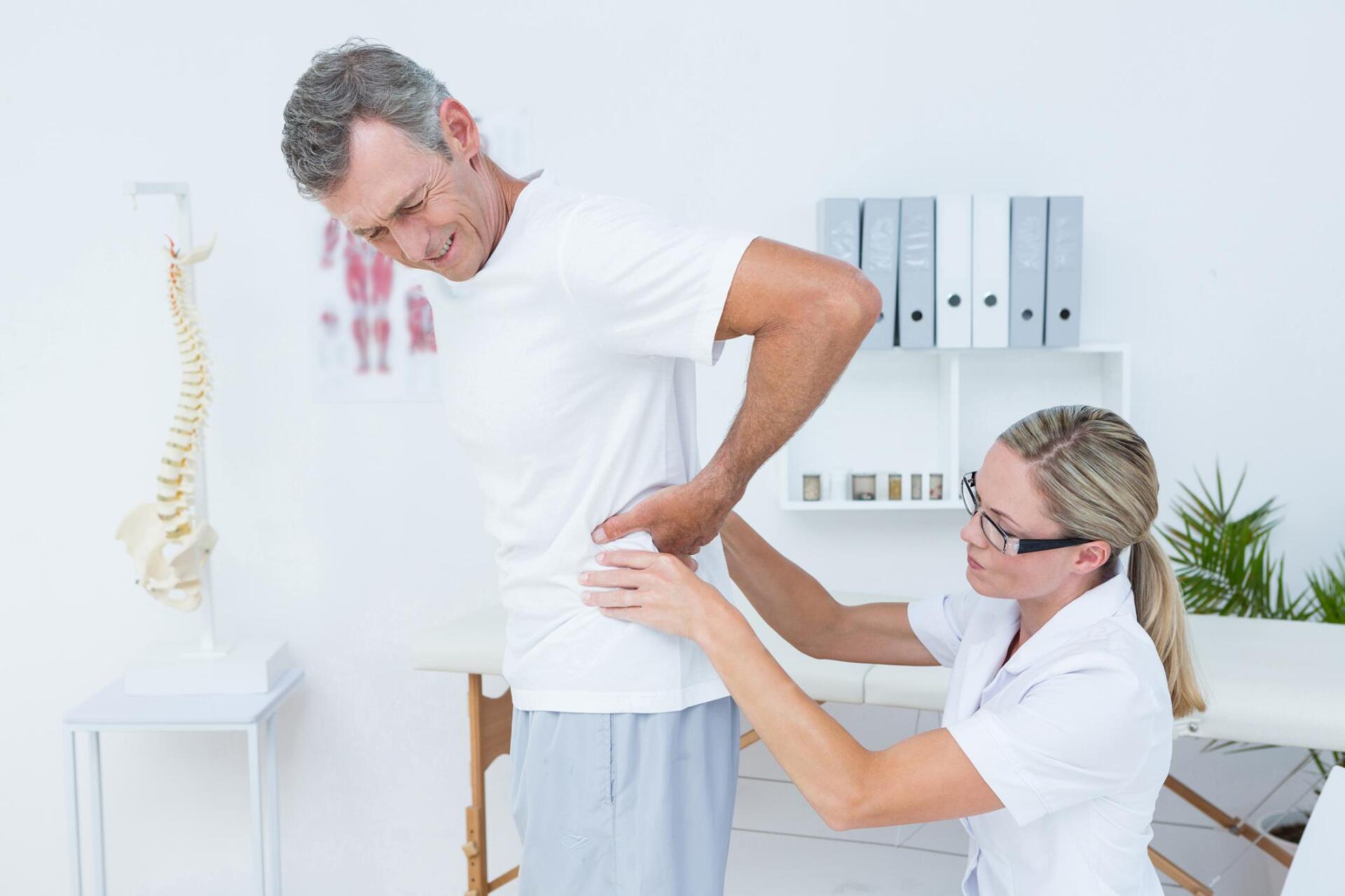 therapist checking the mans waist