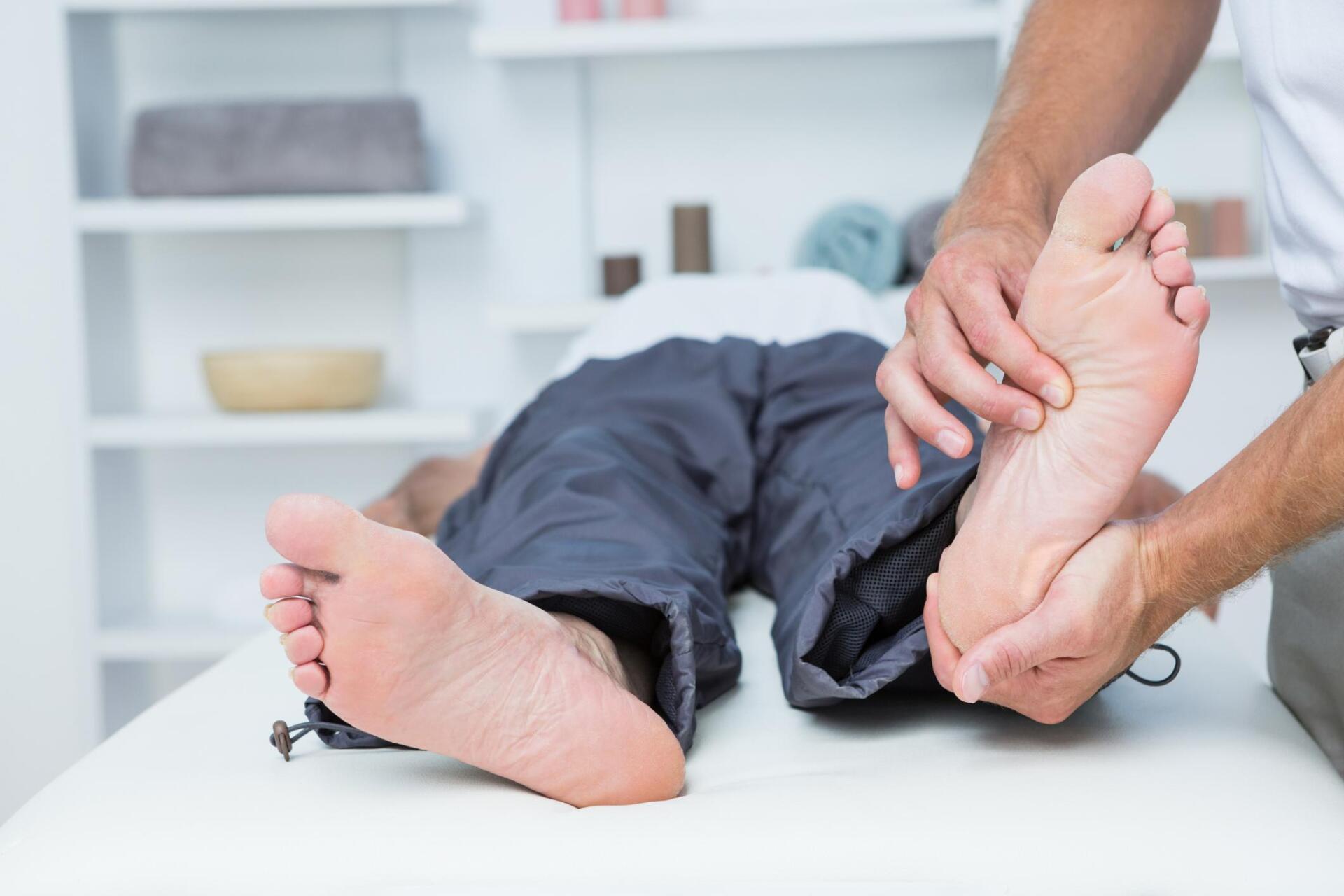 therapist massaging the patients foot