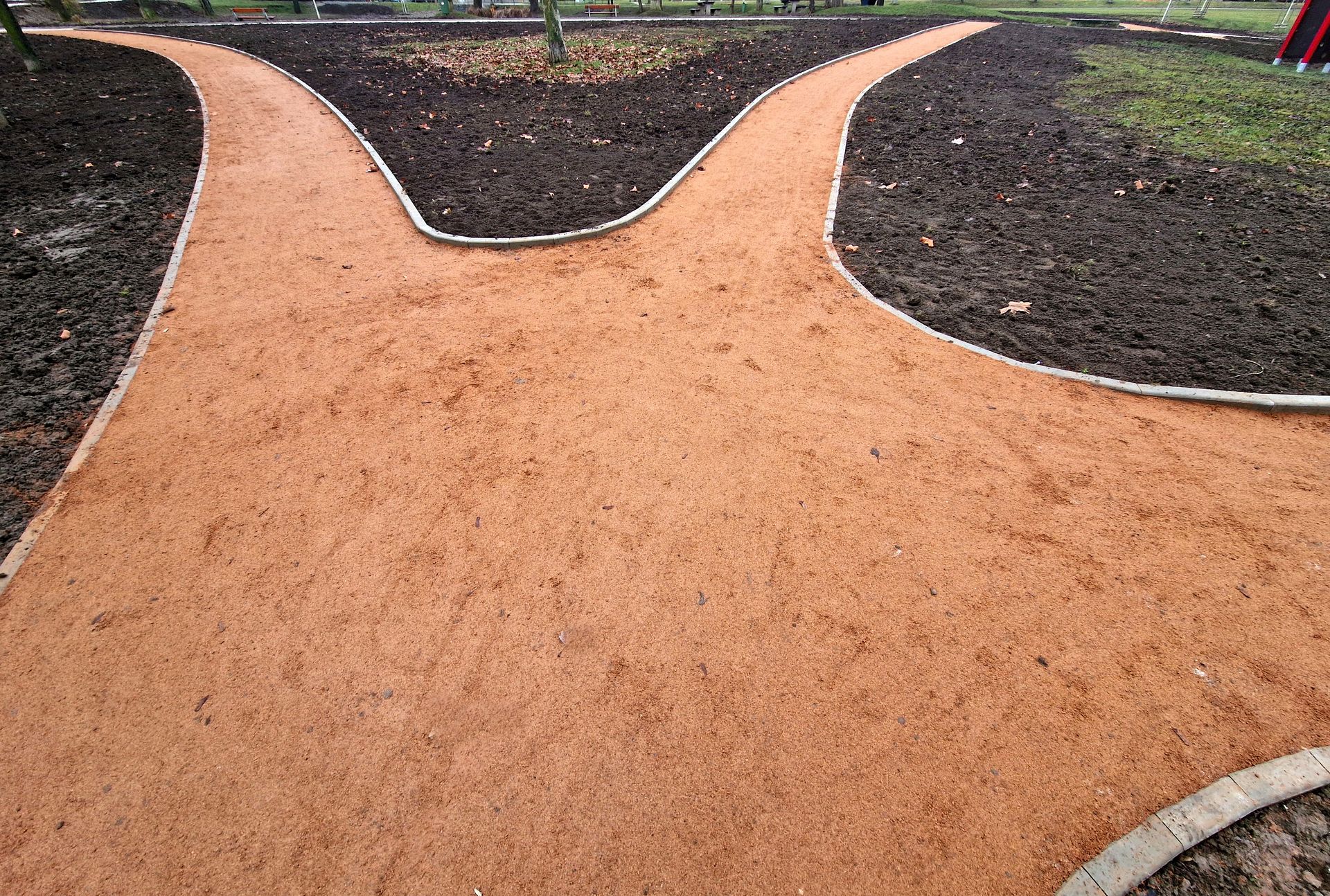 Granite steps and retaining wall with decorative concrete blocks and potted evergreen.