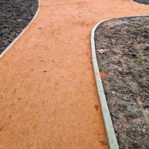 Grey stone pavers set in green grass.