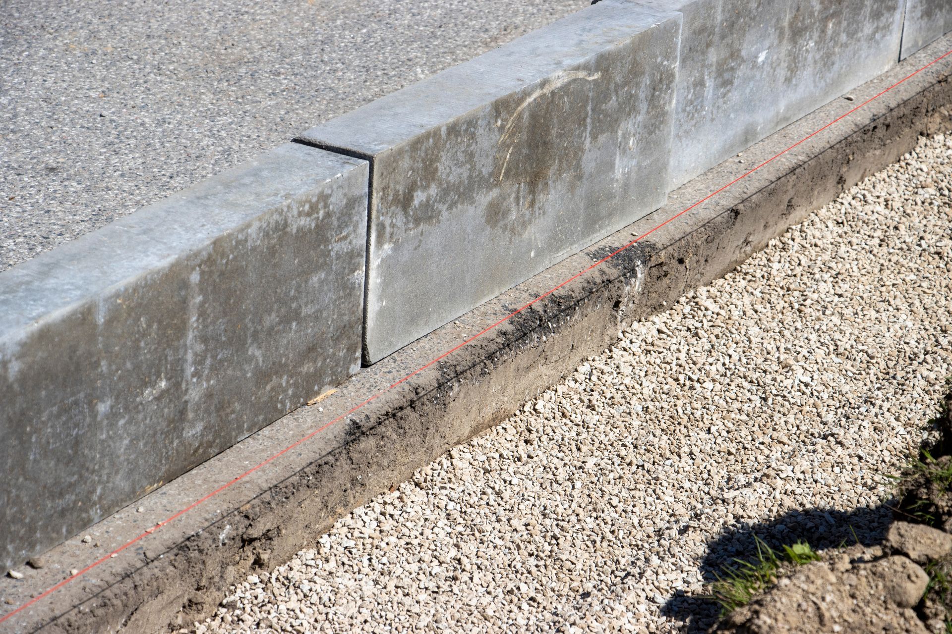 Overhead view of a garden with a winding stone path, small trees, grass, and a pool.