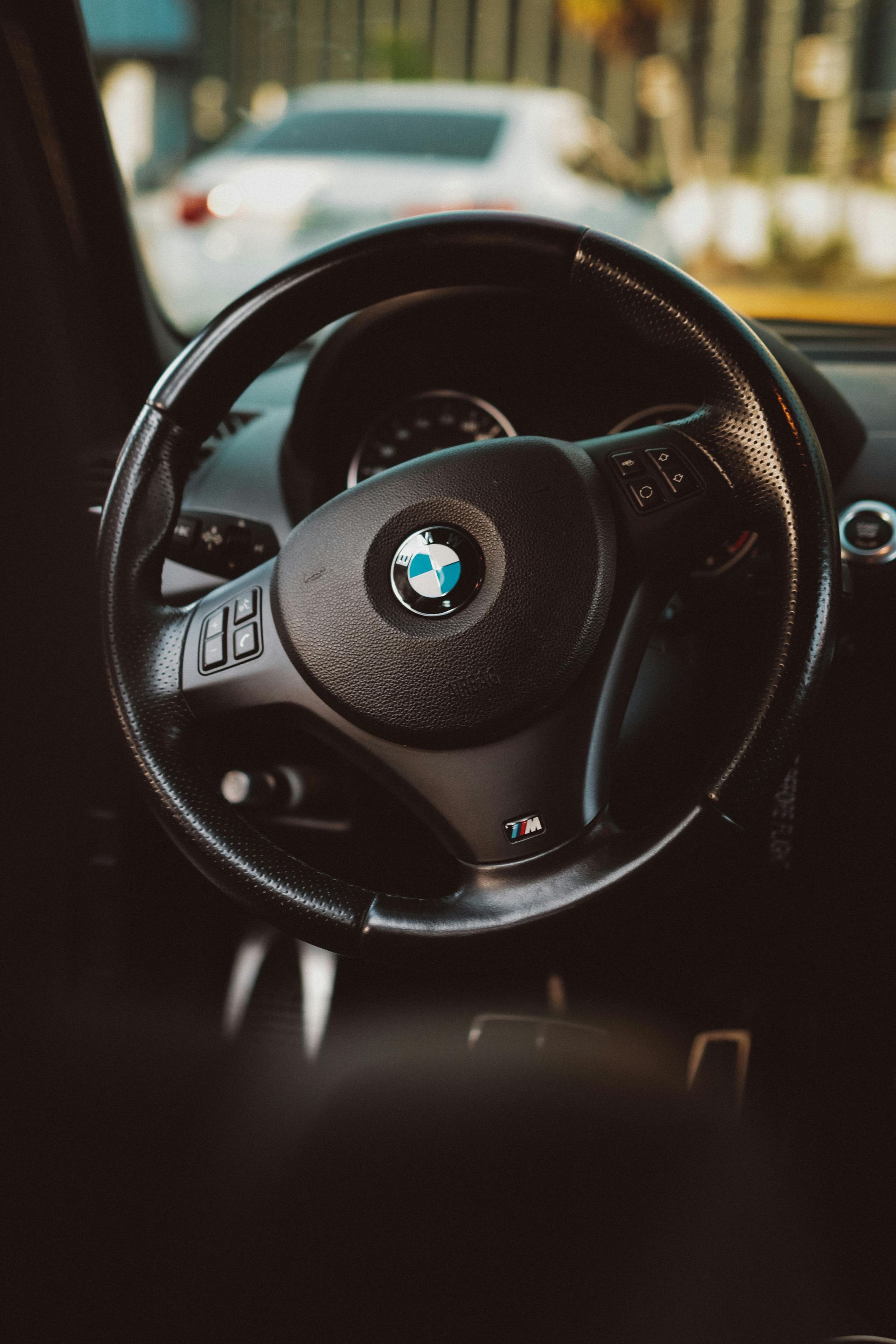 A close up of a bmw steering wheel in a car  | All Automotive