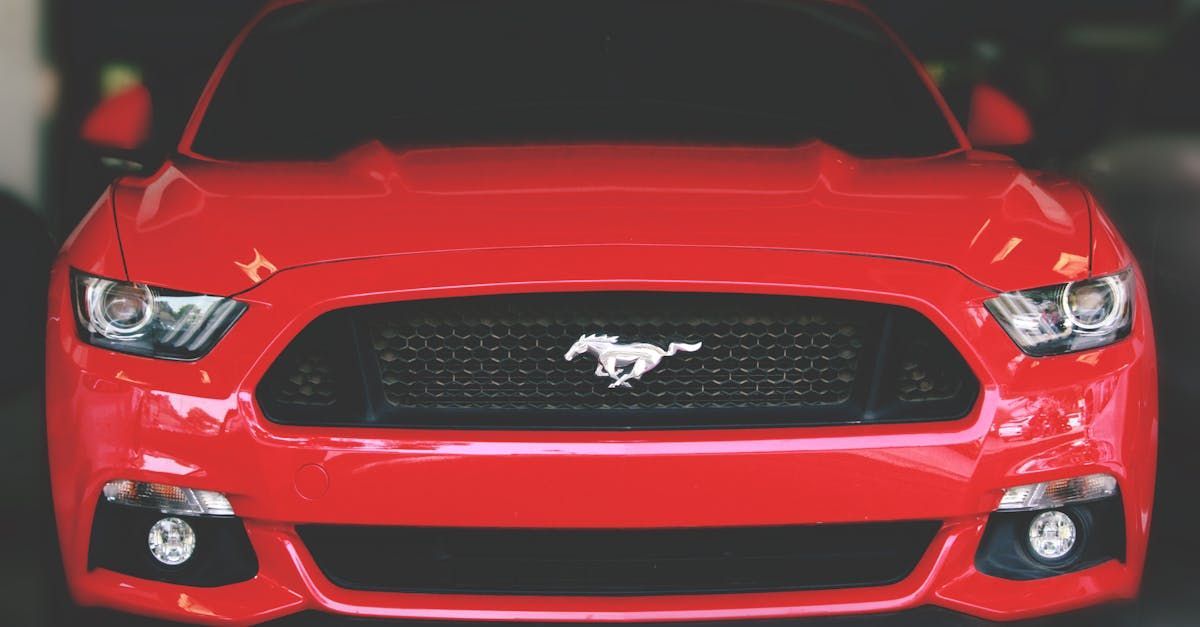 A red ford mustang is parked in a garage.  | All Automotive